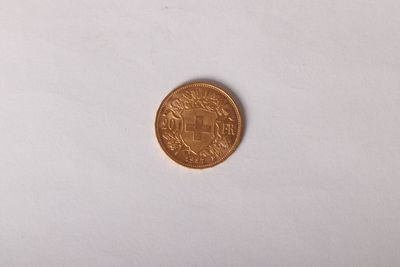 a close up of a coin on a white surface with a white background