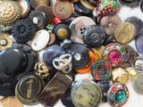 a pile of assorted buttons on a table