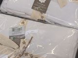 two white sheets wrapped in plastic and tied with a brown ribbon
