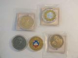 four different types of coins sitting on top of a white surface