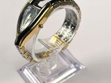 an image of a close up of a wrist watch on a stand