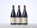 three bottles of wine sitting on top of a table next to each other