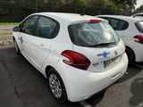 two white cars parked in a parking lot next to each other
