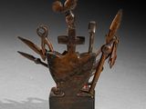 a wooden sculpture of a boat with tools in it