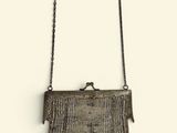 an image of a woven purse hanging on a wall