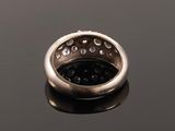 a close up of a silver ring on a black surface