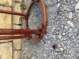 a wooden coat rack on the side of a stone wall