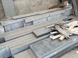 a pile of concrete blocks on the ground next to a building