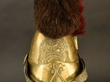 an old helmet with a fur on top of it on a stand