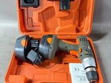 a tool in the orange case that is on the floor