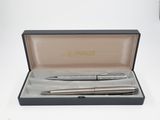 a silver pen and a silver ballpoint pen in a black box