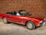 an image of a red convertible car parked in a garage