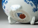 a blue and white vase with a dragon design on it