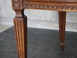 a wooden bench that is sitting on a black mat