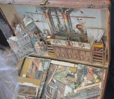 a suitcase full of books sitting on top of a table