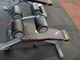 a gym bench that has a pair of weights on top of it