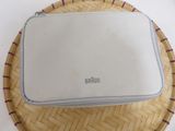 a white bag sitting on top of a wicker tray