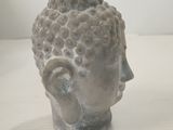 a small statue of a head on a table
