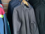 a lot of clothes hanging on a rack in a store