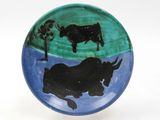a plate with a picture of a bull and a cow on it