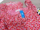 a pink dress with red and white polka dots on it