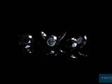 a group of three black diamonds on a black surface