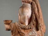 statue of a man holding a cup in his right hand