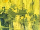 yellow and black painting with writing on it in front of a brick wall