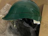 a green helmet sitting on top of a cardboard box