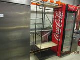 a coca cola machine in the middle of a room
