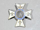 a blue and white cross with a medal on it