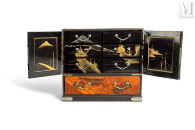 a black and gold chest with four drawers on it