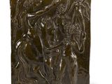 a bronze plaque depicting a group of people on horseback