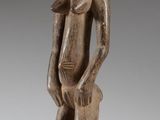 an image of a wooden statue of a man standing on a pedestal