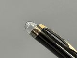 the pen is black and gold with a silver tip