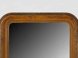 an image of a mirror with a wooden frame on a white wall