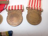 two medals and a ribbon on a table with a ribbon