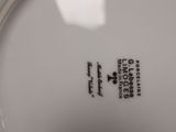a close up of a white plate with black writing on it