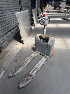 a fork lifter that is sitting in the middle of the street