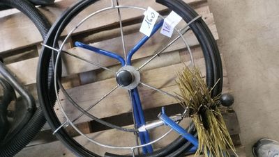 a wheel with a blue spoke and a brush next to it