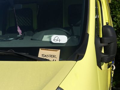 a yellow van that has a sign on the front of it