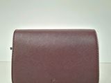 a brown purse sitting on top of a white table