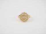 a yellow gold ring with a cluster of white diamonds
