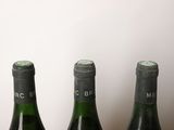 three bottles of wine that are sitting on a table
