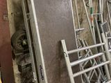 many metal ladders stacked on top of each other in a room