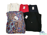 three women ' s dress pants and a top with a label on them