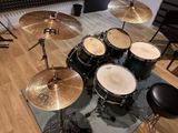 a drum set that is sitting on a rug in a room