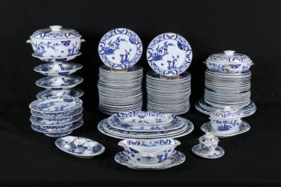 many blue and white plates and bowls on a black table