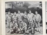 a group of men standing in front of an airplane