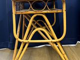 an image of a rattan table with four legs and a small table top